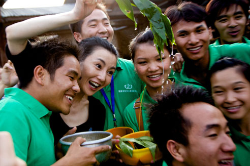 2010年4月，云南省德宏州瑞丽市某村，联合国儿童基金会中国大使张曼玉为在社区里开展预防艾滋病宣传教育的青少年爱心大使们送上祝福。