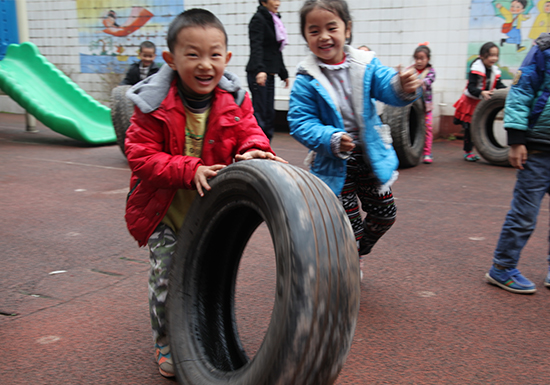  Children playing recycled tire